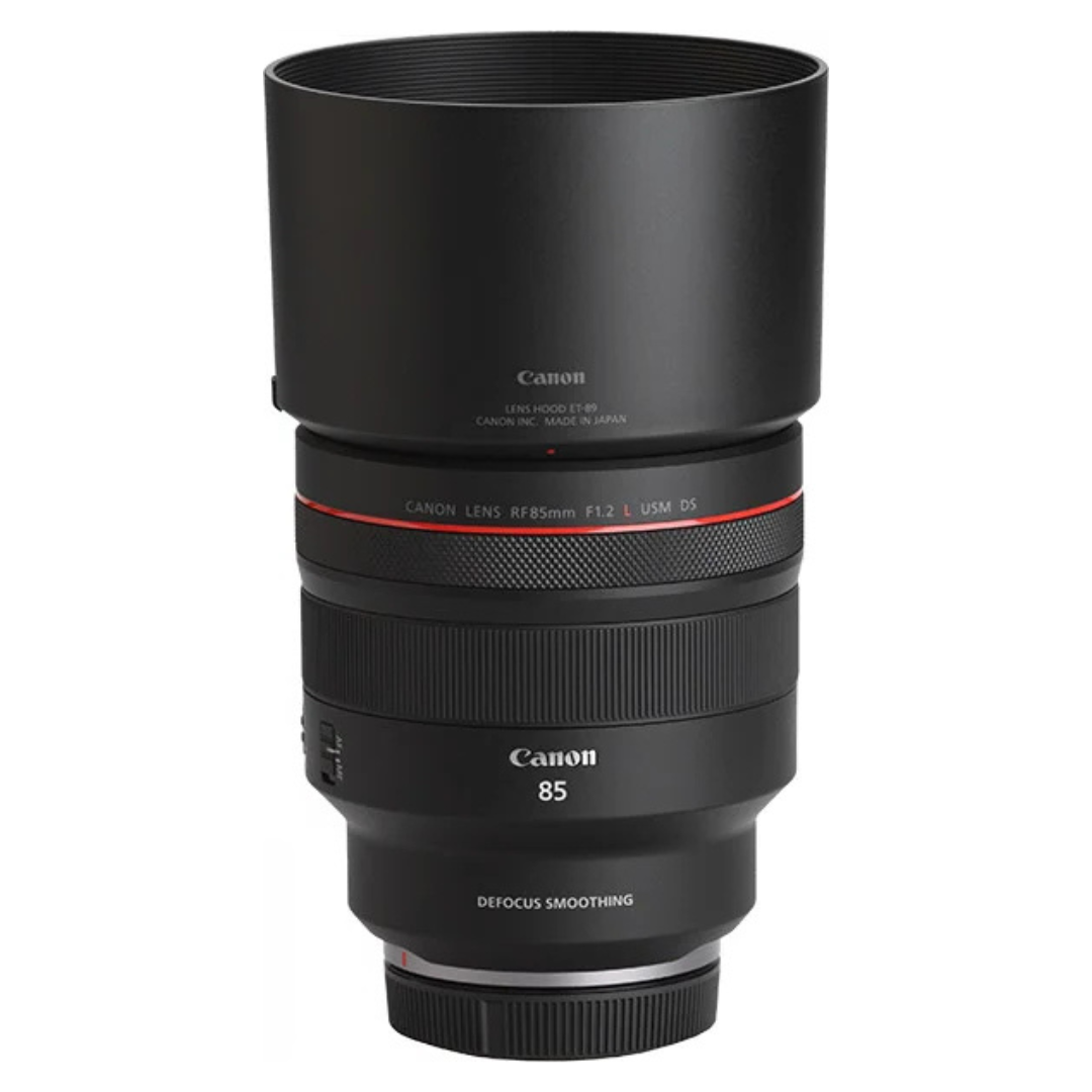 Side view of the Canon RF 85mm f/1.2L USM DS Lens with lens hood fitted, on a white background.