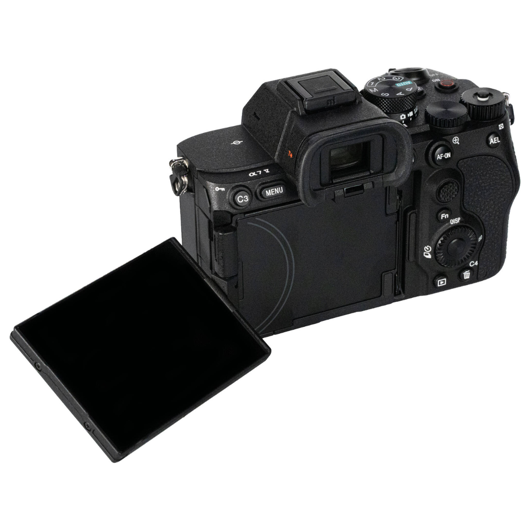 Rear angle view of the Sony A7 V camera with its rear screen flipped open, on a white background.